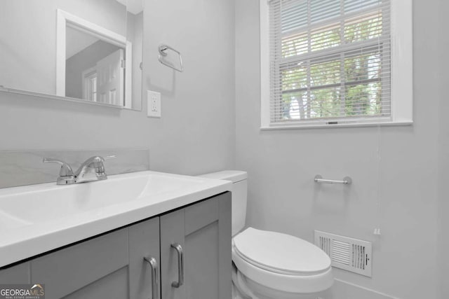 1093 Lanier Dr SW, Marietta, GA 30060 - bathroom featuring visible vents, toilet, and vanity
