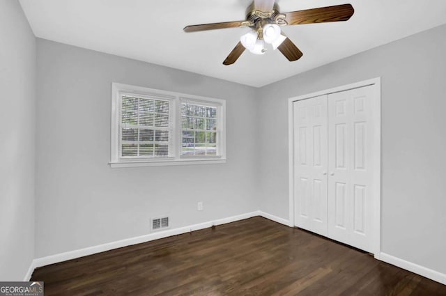 1093 Lanier Dr SW, Marietta, GA 30060 - unfurnished bedroom with visible vents, baseboards, a closet, dark wood-style flooring, and ceiling fan