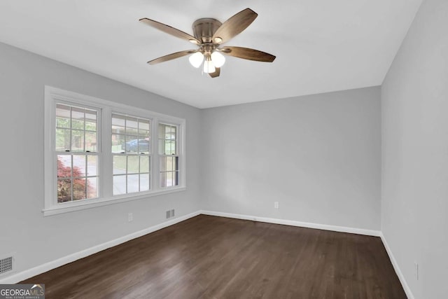 1093 Lanier Dr SW, Marietta, GA 30060 - unfurnished room featuring dark wood-style floors, baseboards, a ceiling fan, and visible vents