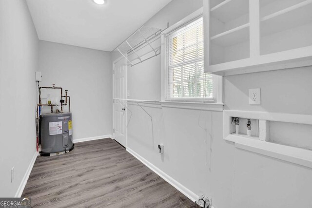 1093 Lanier Dr SW, Marietta, GA 30060 - clothes washing area with baseboards, laundry area, wood finished floors, water heater, and hookup for a washing machine