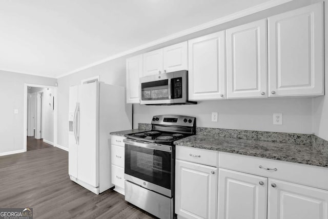 1093 Lanier Dr SW, Marietta, GA 30060 - kitchen featuring dark wood finished floors, appliances with stainless steel finishes, white cabinetry, and light stone countertops
