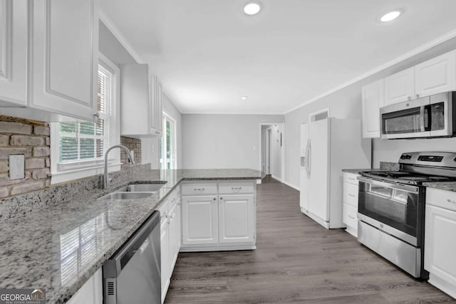1093 Lanier Dr SW, Marietta, GA 30060 - kitchen featuring a sink, a peninsula, appliances with stainless steel finishes, and white cabinetry