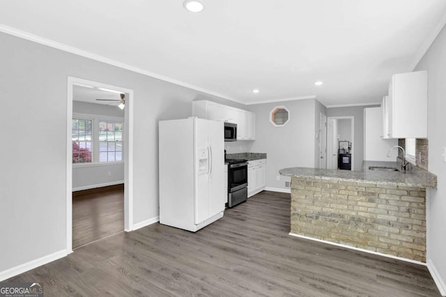 1093 Lanier Dr SW, Marietta, GA 30060 - kitchen featuring white fridge with ice dispenser, electric range, ornamental molding, stainless steel microwave, and a sink