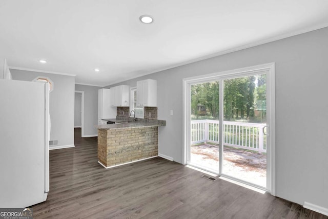 1093 Lanier Dr SW, Marietta, GA 30060 - kitchen featuring visible vents, white cabinets, freestanding refrigerator, dark wood finished floors, and crown molding
