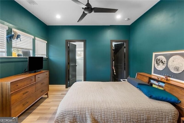 bedroom featuring light wood-style flooring, ceiling fan, multiple windows, and recessed lighting