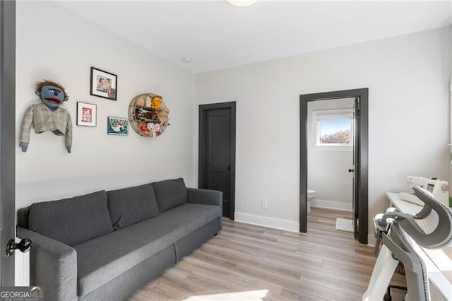 living room with light wood-style flooring and baseboards