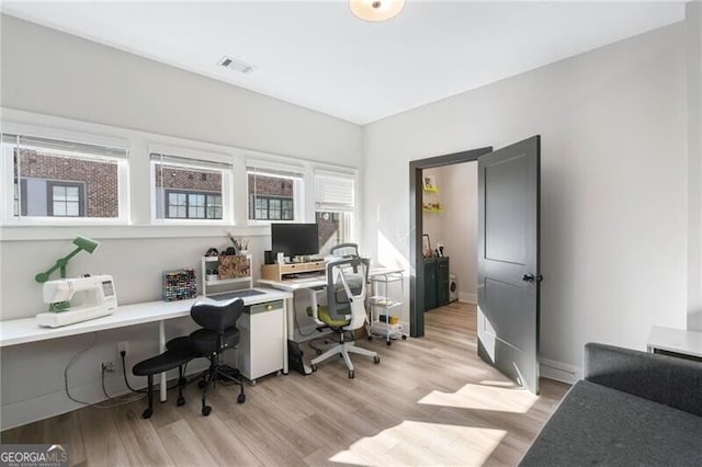office area featuring visible vents and light wood-style flooring