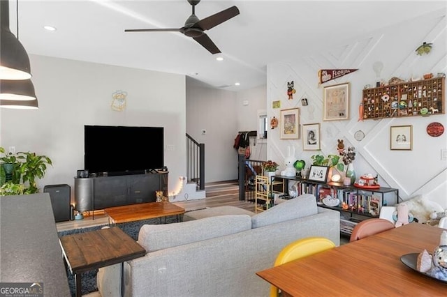 living area featuring wood finished floors, recessed lighting, a ceiling fan, and stairs