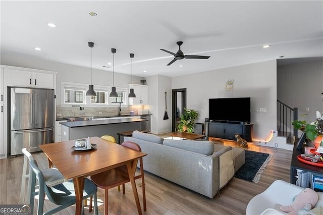 living room featuring wood finished floors, ceiling fan, and recessed lighting