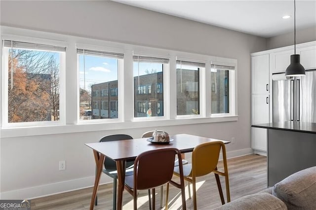 dining room with light wood-style floors, baseboards, and recessed lighting