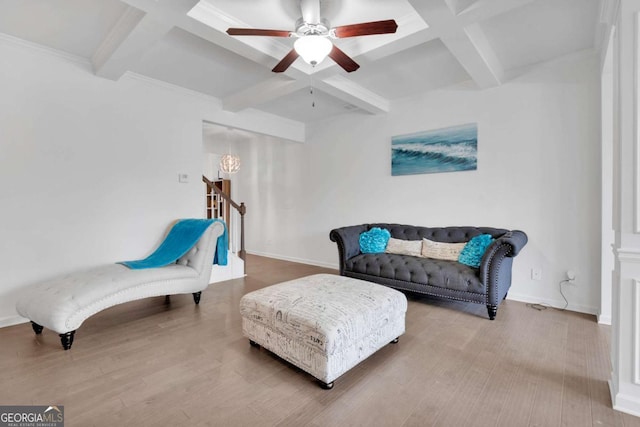 living area with baseboards, a ceiling fan, beamed ceiling, wood finished floors, and coffered ceiling