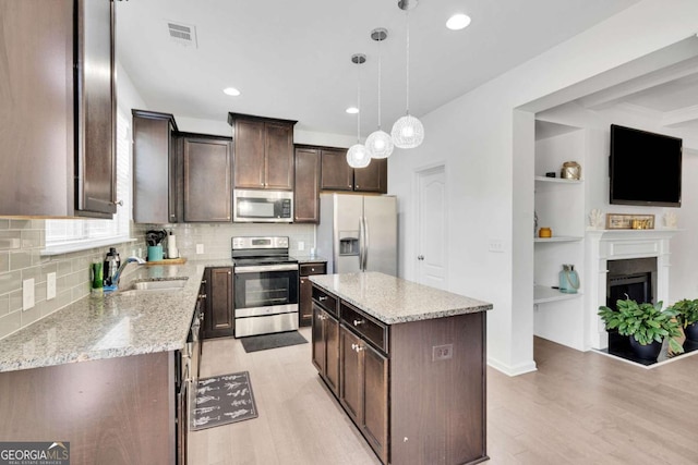 kitchen featuring visible vents, light wood-type flooring, dark brown cabinets, and appliances with stainless steel finishes