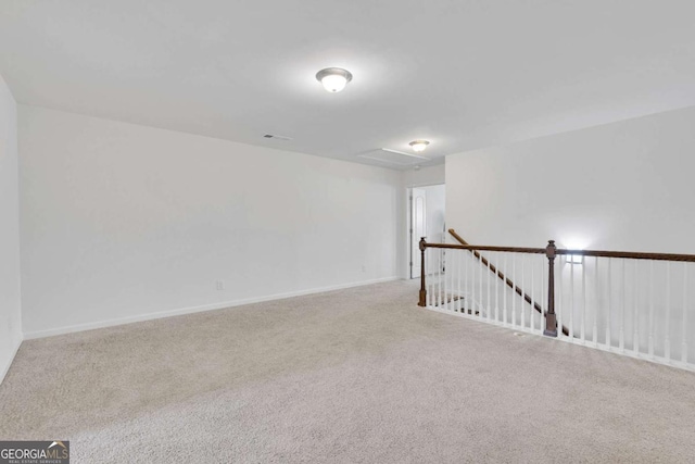 carpeted empty room featuring baseboards