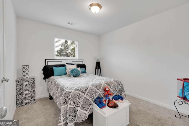 carpeted bedroom with visible vents and baseboards
