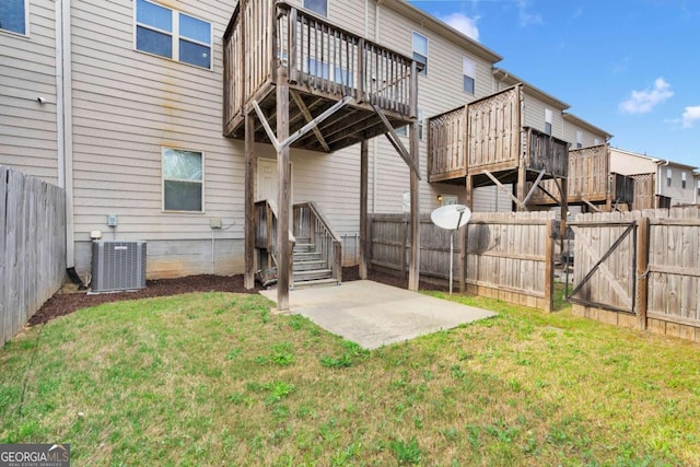 rear view of house featuring central AC, a yard, a patio, fence, and a deck