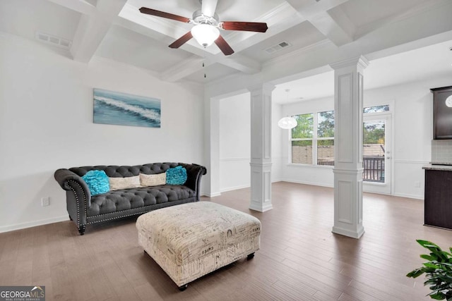 living area with visible vents, ceiling fan, decorative columns, beam ceiling, and coffered ceiling