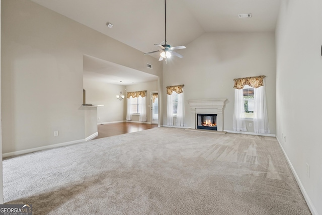 unfurnished living room featuring a glass covered fireplace, carpet flooring, a ceiling fan, baseboards, and high vaulted ceiling