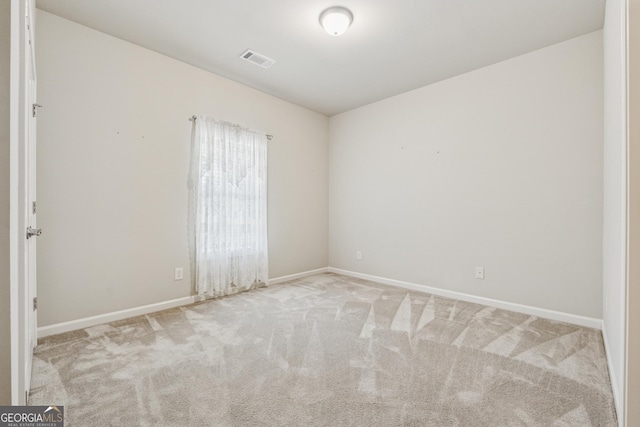 carpeted empty room with baseboards