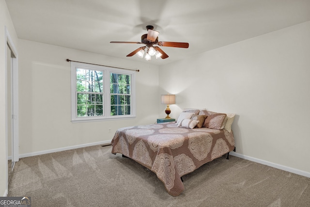 carpeted bedroom featuring baseboards and a ceiling fan