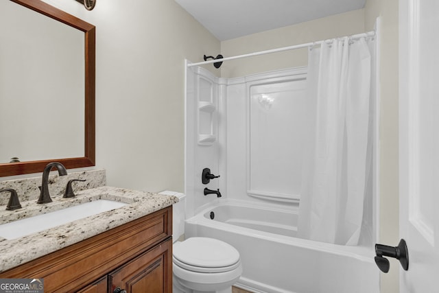 bathroom with toilet, shower / bath combo, and vanity