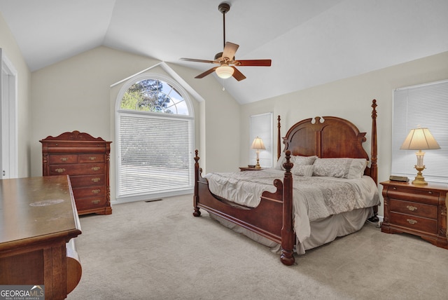 carpeted bedroom with ceiling fan and lofted ceiling