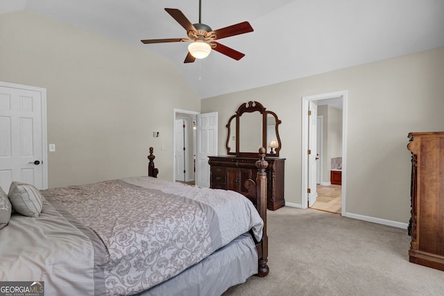 bedroom with baseboards, vaulted ceiling, light carpet, ensuite bath, and a ceiling fan