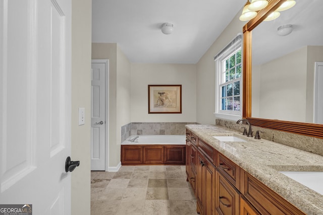 full bathroom featuring a garden tub, double vanity, a sink, and baseboards