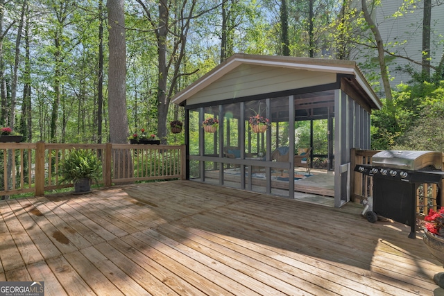 wooden terrace featuring grilling area and a sunroom