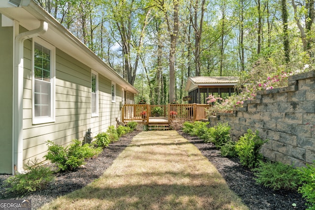 view of yard featuring a wooden deck and fence