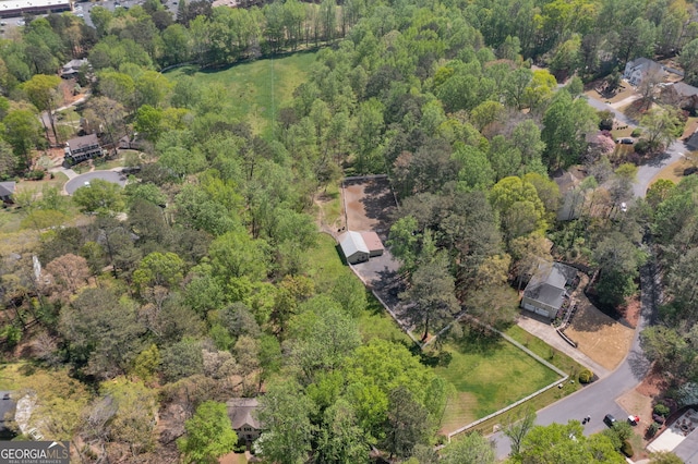 birds eye view of property featuring a forest view