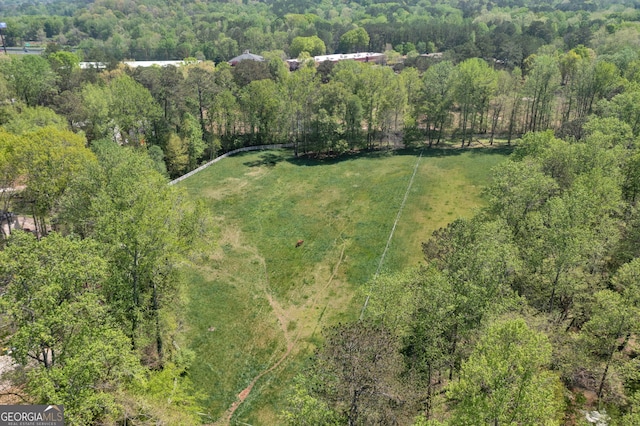 birds eye view of property with a view of trees