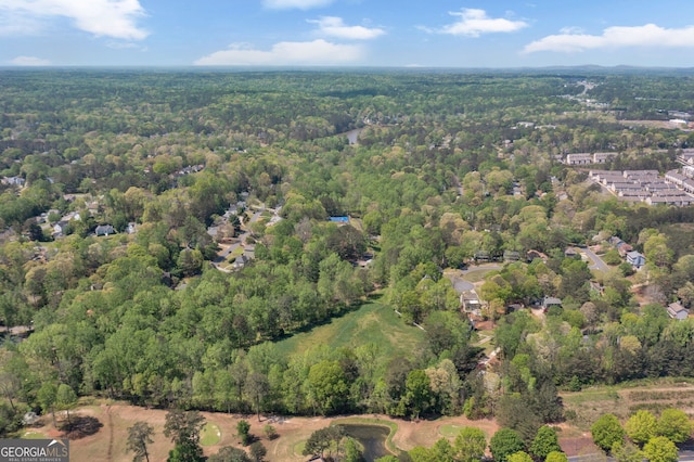 birds eye view of property featuring a wooded view