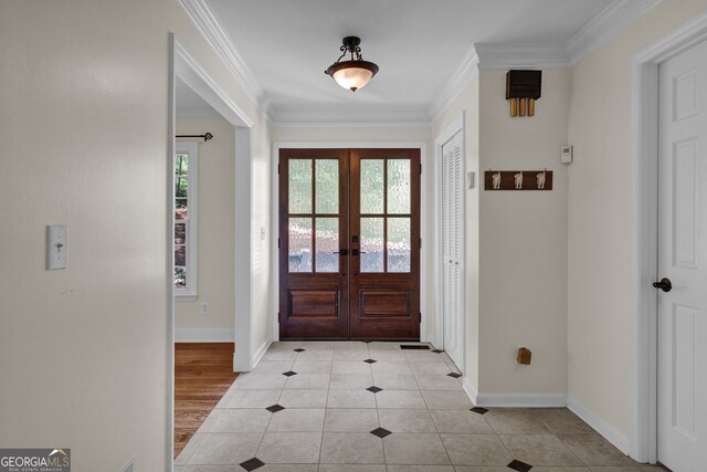entryway featuring crown molding, french doors, baseboards, and light tile patterned floors