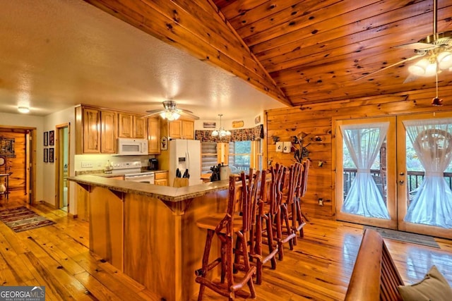 kitchen with ceiling fan, white appliances, light wood-style flooring, lofted ceiling, and french doors