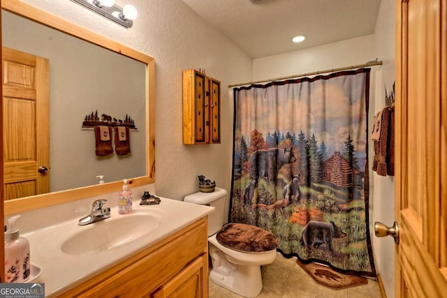 full bathroom featuring tile patterned floors, curtained shower, vanity, and toilet