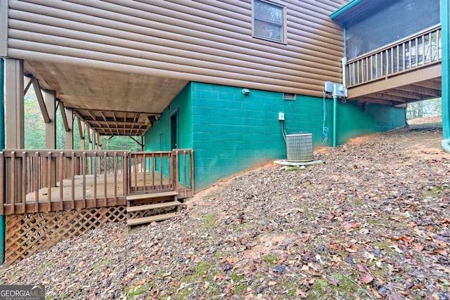 view of property exterior featuring central AC unit and log veneer siding