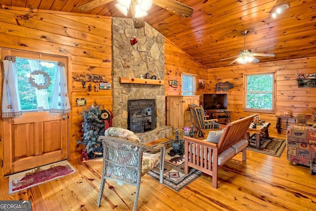 living room with ceiling fan, hardwood / wood-style floors, and lofted ceiling