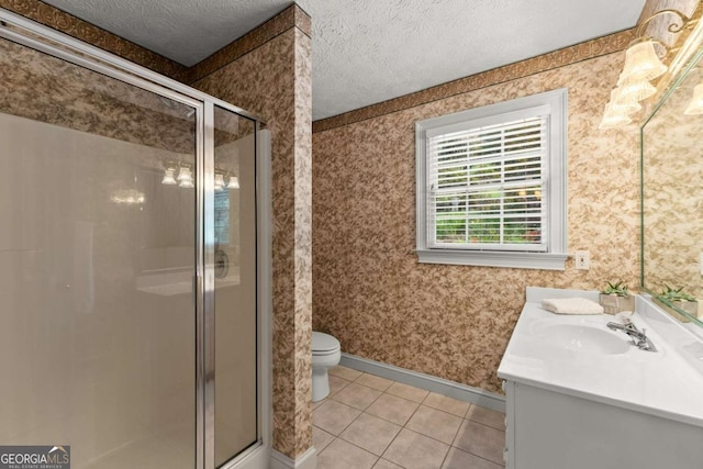 full bath featuring vanity, wallpapered walls, tile patterned flooring, a textured ceiling, and a shower stall