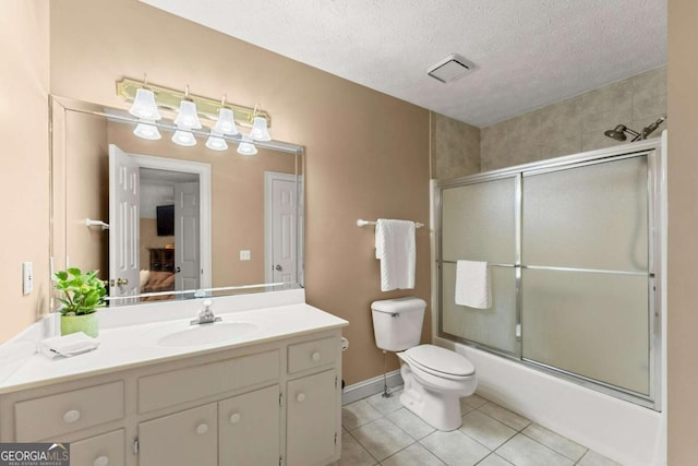 full bath featuring shower / bath combination with glass door, vanity, tile patterned floors, toilet, and visible vents