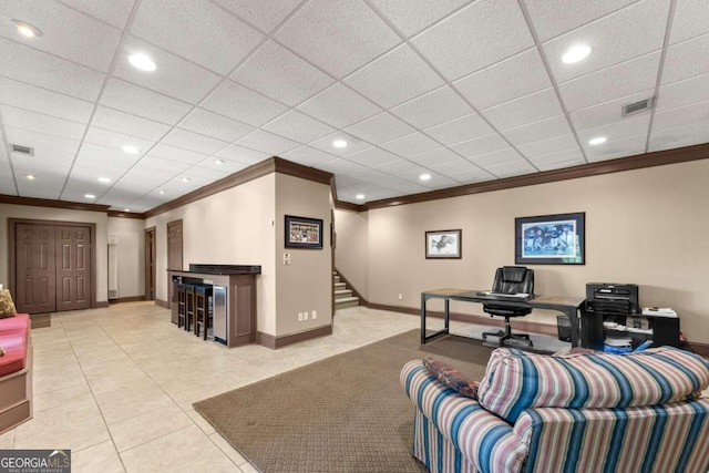 office featuring crown molding, baseboards, tile patterned flooring, and visible vents