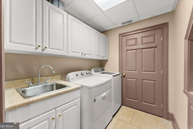 laundry area featuring light tile patterned floors, visible vents, cabinet space, washer and dryer, and a sink