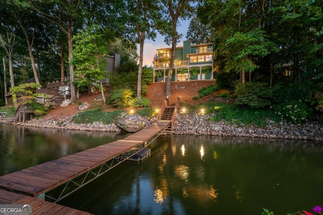dock area featuring stairway and a water view