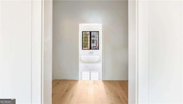 hallway with wood finished floors