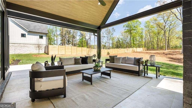 view of patio / terrace featuring an outdoor living space and fence