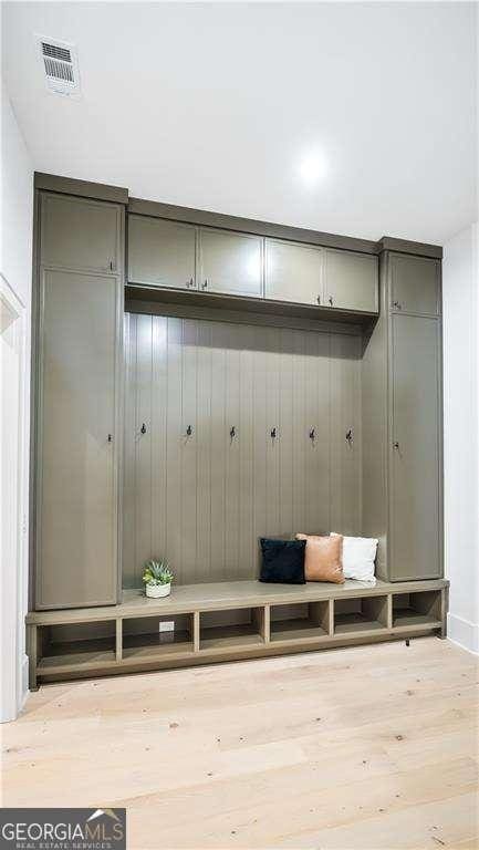 mudroom with visible vents and wood finished floors