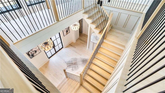stairs with french doors and wood finished floors