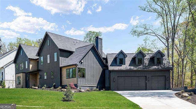 modern inspired farmhouse featuring board and batten siding, a front yard, an attached garage, a shingled roof, and driveway