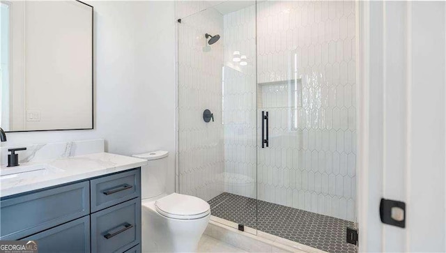 full bath featuring a shower stall, vanity, and toilet