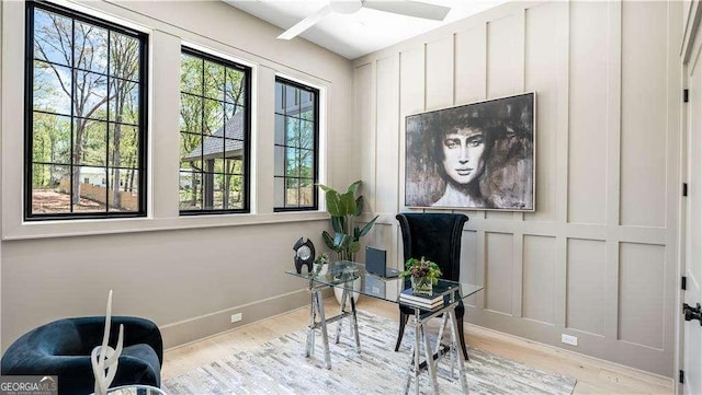 office space with wood finished floors, ceiling fan, and baseboards