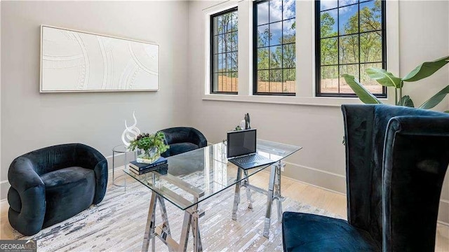 office featuring baseboards and wood finished floors